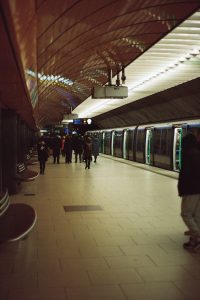 a group of people walking down a subway platform
